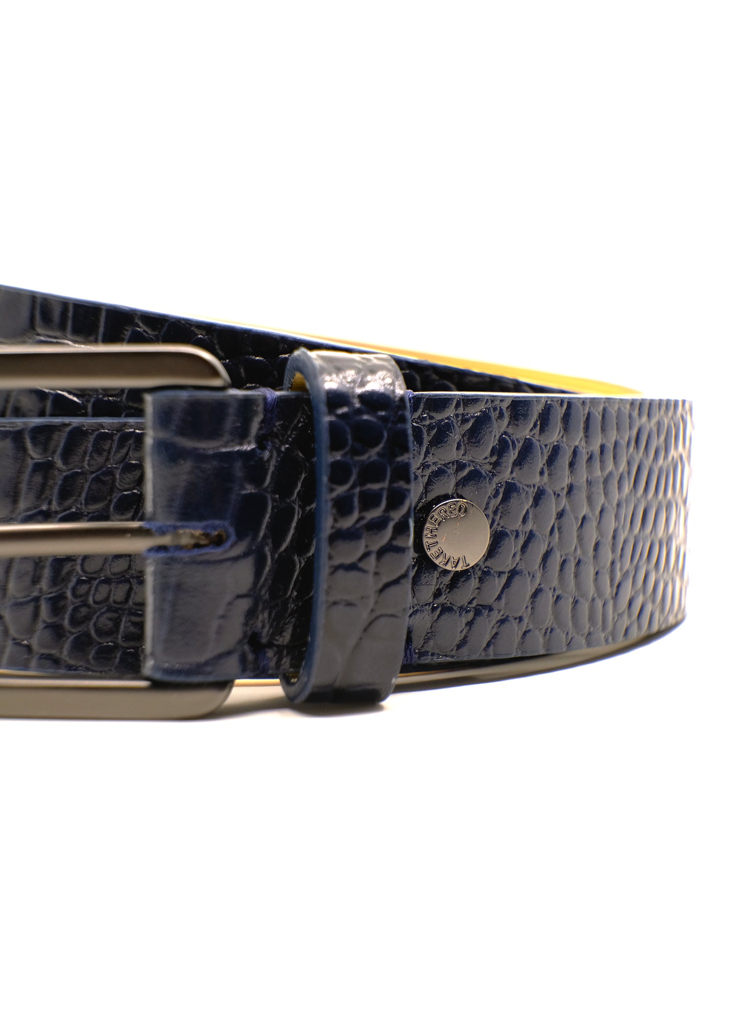 Close-up of the navy Mississippi Belt showing alligator-embossed leather, a matte black buckle and a silver rivet.