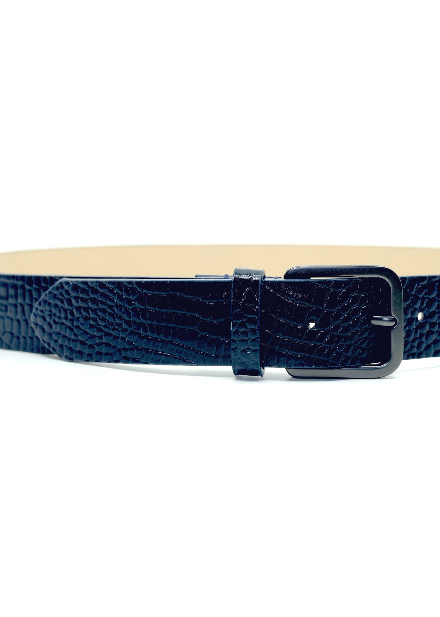 Close-up horizontal view of the navy alligator-embossed Mississippi Belt with a matte black buckle and cream interior.