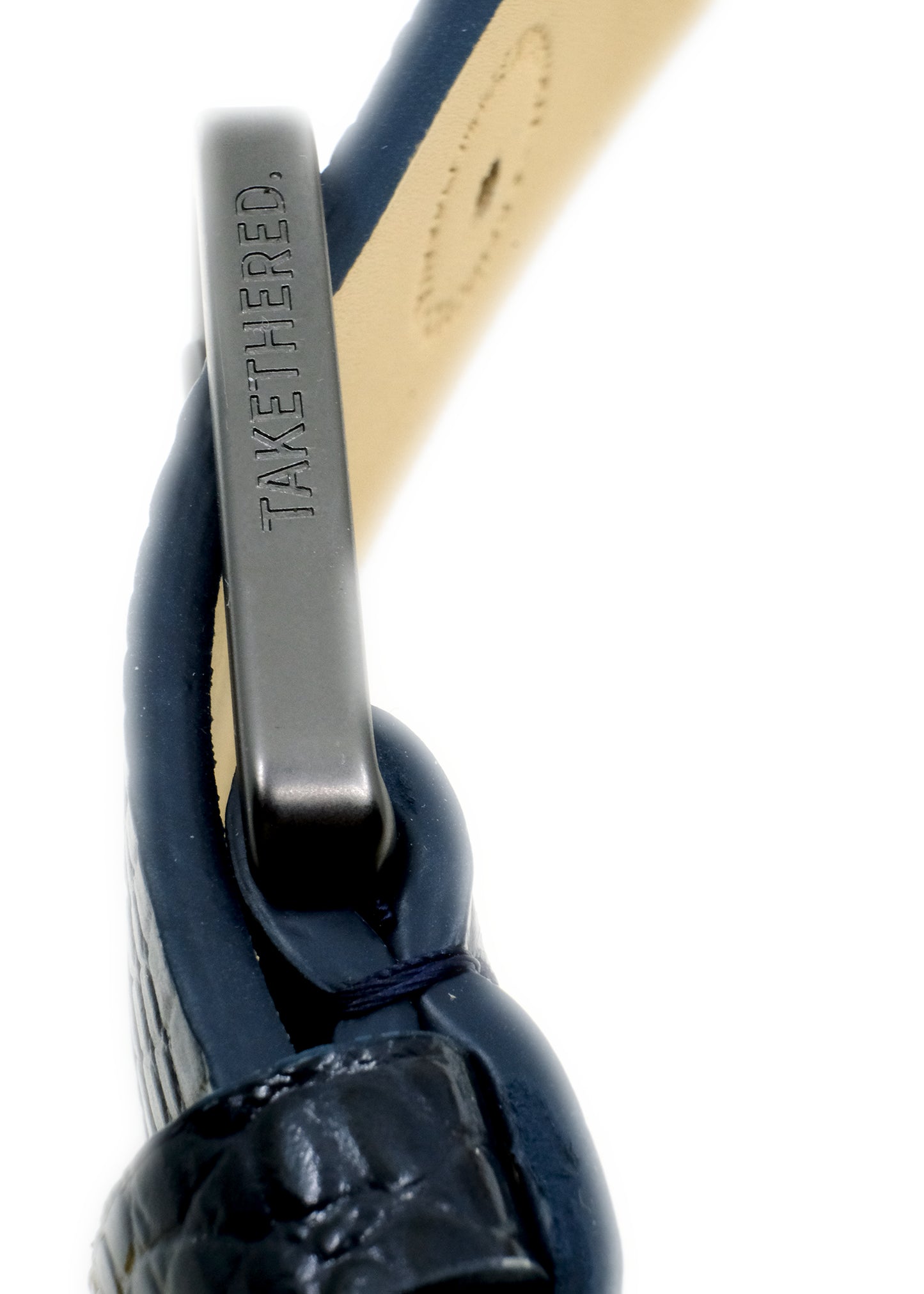 Side view of the navy Big Blue Mississippi Belt showing a matte black buckle engraved with "TAKETHERED."