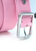 Close-up of Barbie Pink leather belt with a weathered silver buckle and "BIRD & ASH." engraved on the side.