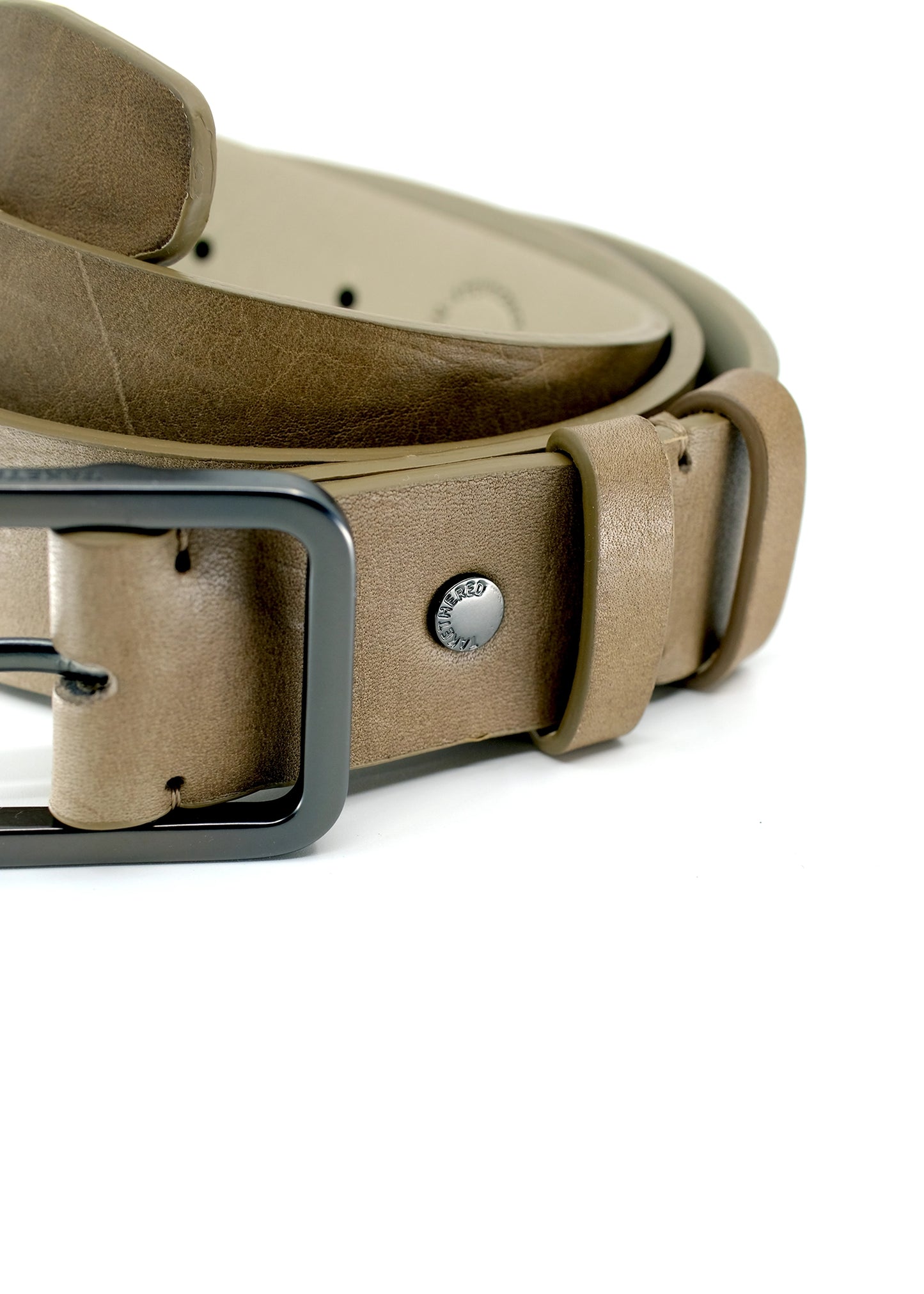 Close-up of Classic Truffle Brown smooth leather belt with gunmetal buckle and silver "TAKETHERED." rivet.