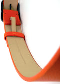 Interior view of an orange belt with the hidden embossed text "When you choose to be puzzled, strange things happen."
