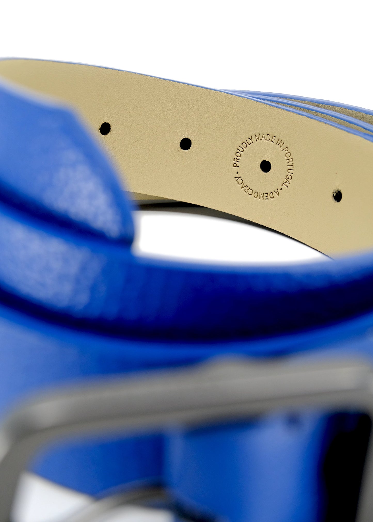 Close-up of a Betty Blue belt's interior showing the "PROUDLY MADE IN PORTUGAL - A DEMOCRACY" embossed stamp.