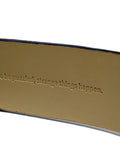 Close-up of the tan belt interior with the embossed hidden text "to be puzzled, strange things happen."