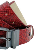 Side-angle macro of the Blood Simple red snakeskin belt, focusing on the matte black reversible buckle's swivel joint and the detailed texture.