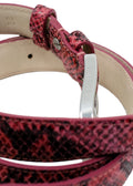 Side-angle macro of the Barbie Pink snakeskin belt, showing the silver buckle and the smooth interior lining.