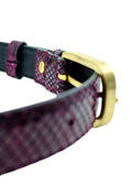 Interior view of the Dark Plum snakeskin belt, focusing on the golden buckle attachment and smooth black lining.