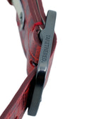 Extreme side-angle macro of the Pink Grape belt, focusing on the branding on the sleek black dull brass buckle.