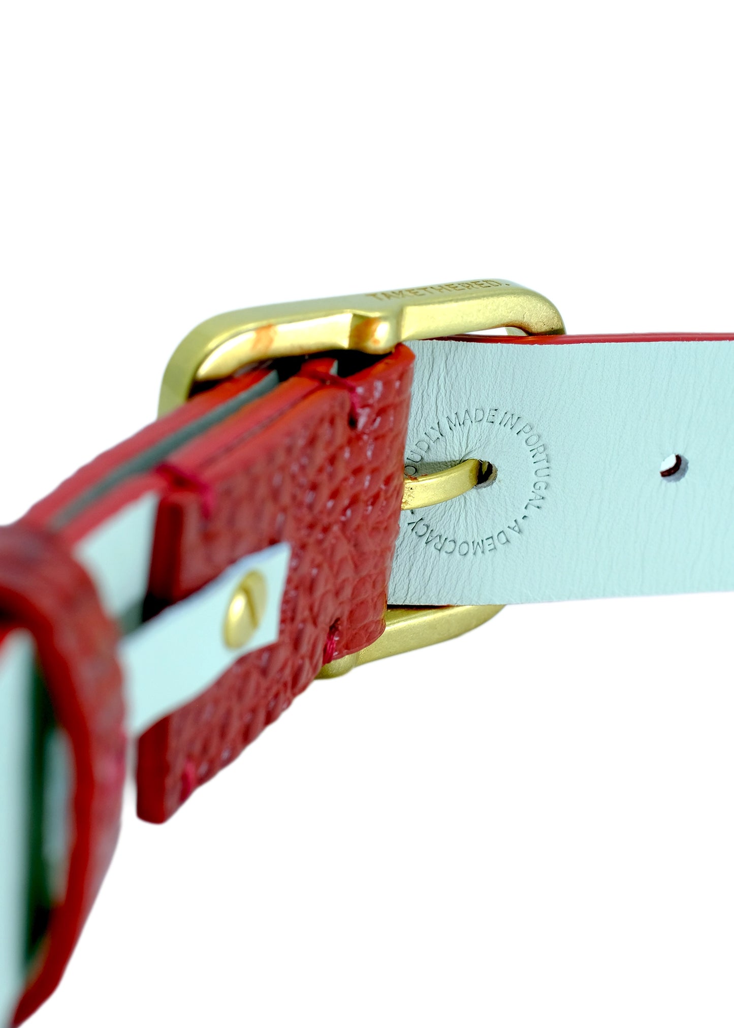 Close-up of the Dry Blood belt's gold buckle and interior lining, featuring the "Proudly Made in Portugal" stamp and high-quality stitching.