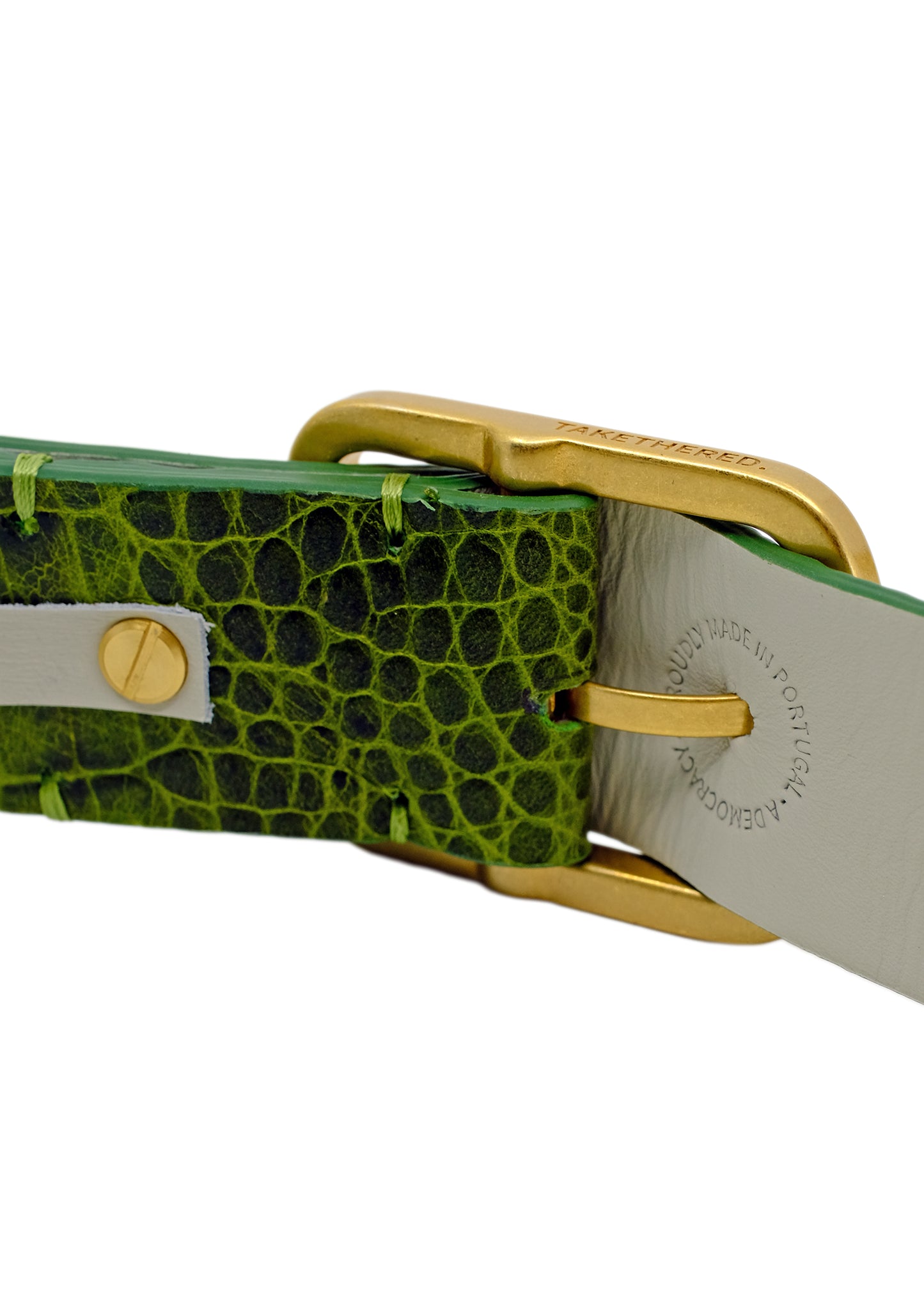 Close-up of the Atomic Green belt's gold buckle and interior lining, featuring the "Proudly Made in Portugal" stamp and high-quality green stitching.