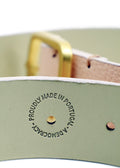 Close-up of the Nude Pink belt interior featuring a "PROUDLY MADE IN PORTUGAL - A DEMOCRACY" embossed stamp.